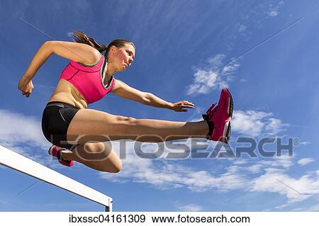 Junge Frau, 20 Jahre, Hurdenlauf View Large Photo Image Stock Photo - Junge Frau, 20 Jahre, Hurdenlauf. Fotosearch