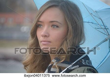 Junge Frau mit blauem Regenschirm im Herbst, Ystad, Schweden, Europa View Large Photo Image Stock Photography - Junge Frau mit blauem Regenschirm im Herbst, Ystad, Schweden, Europa. Fotosearch