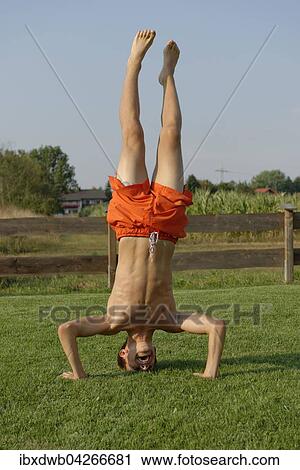 Junge, Teenager macht Kopfstand, Oberbayern, Bayern, Deutschland, Europa View Large Photo Image Stock Image - Junge, Teenager macht Kopfstand, Oberbayern, Bayern, Deutschland, Europa. Fotosearch