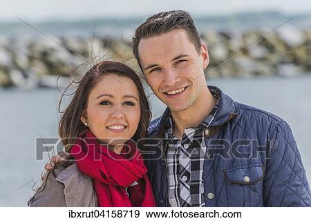 Stock Photo - Junges Paar am Yachthafen, Portrait, Boltenhagen, Mecklenburg-Vorpommern, Deutschland, Europa. Fotosearch