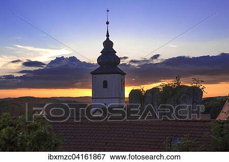 Stock Photo - Kirchturm der Matthauskirche und Felsen, Abendstimmung, Hiltpoltstein, Oberfranken, Bayern, Deutschland, Europa. Fotosearch