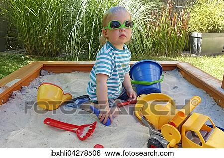 Kleinkind, Madchen spielt im Sandkasten, Deutschland, Europa View Large Photo Image Stock Photograph - Kleinkind, Madchen spielt im Sandkasten, Deutschland, Europa. Fotosearch