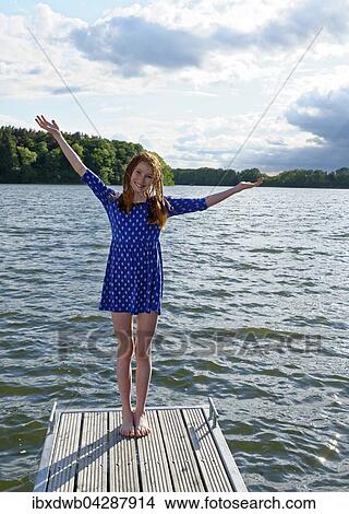 Madchen auf einem Steg, Ellbogensee, Mecklenburger Seenplatte, Mecklenburg-Vorpommern, Deutschland, Europa View Large Photo Image Picture - Madchen auf einem Steg, Ellbogensee, Mecklenburger Seenplatte, Mecklenburg-Vorpommern, Deutschland, Europa. Fotosearch