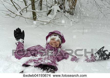 Madchen liegt im Schnee im Winter, Oberbayern, Bayern, Deutschland, Europa View Large Photo Image Picture - Madchen liegt im Schnee im Winter, Oberbayern, Bayern, Deutschland, Europa. Fotosearch
