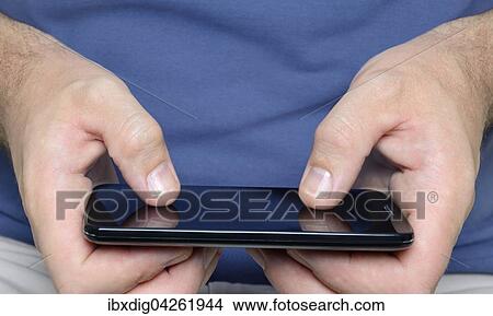 Mann mit einem Smartphone, Nachaufnahme View Large Photo Image Picture - Mann mit einem Smartphone, Nachaufnahme. Fotosearch