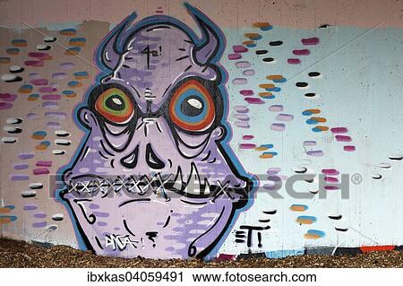 Stock Image - Monster mit Hornern und zugenahtem Mund, Wandbild, Streetart, Dusseldorf, Nordrhein-Westfalen, Deutschland, Europa. Fotosearch