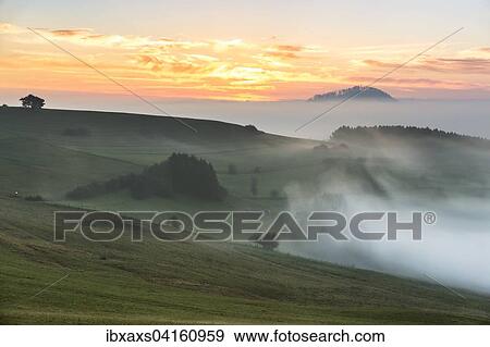 Stock Photo - Morgendlicher Hochnebel am alten Postweg, Ausblick auf Hohenhewen, Watterdingen, Tengen, Baden-Wurttemberg, Deutschland, Europa. Fotosearch