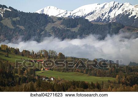 Stock Image - Morgennebel liegt im Tal, hinten die Allgauer Berge, bei Bad Hindelang, Allgau, Bayern, Deutschland, Europa. Fotosearch