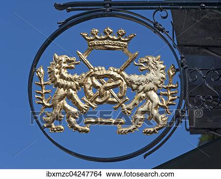 Nasenschild einer Backerei mit Lowen und Brezel, blauer Himmel, Hitzacker, Niedersachsen, Deutschland, Europa View Large Photo Image Picture - Nasenschild einer Backerei mit Lowen und Brezel, blauer Himmel, Hitzacker, Niedersachsen, Deutschland, Europa. Fotosearch