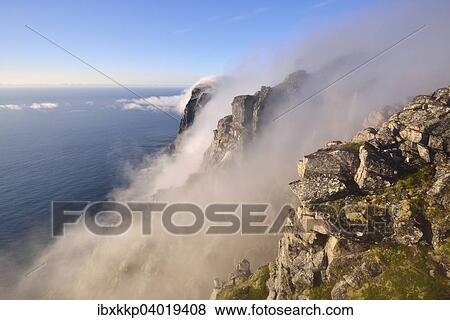 Nebel fallt eine steile Felswand hinab zum Meer, Berg Ryten, Insel Moskenesoy, Lofoten, Norwegen, Europa View Large Photo Image Stock Photo - Nebel fallt eine steile Felswand hinab zum Meer, Berg Ryten, Insel Moskenesoy, Lofoten, Norwegen, Europa. Fotosearch