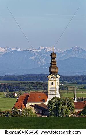 Stock Image - Pfarrkirche Maria Himmelfahrt, hinten die Berchtesgadener Alpen, Schnaitsee, Chiemgau, Oberbayern, Bayern, Deutschland, Europa. Fotosearch