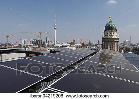 Stock Photo - Photovoltaikanlage mit Dunnschichtmodulen auf dem Dach des Kaufhauses Galeries Lafayette, hinten Turm vom Franzosischen Dom und Fernsehturm, Berlin, Deutschland, Europa. Fotosearch