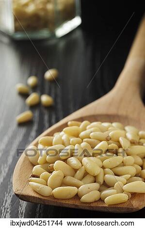 Picture - Pinienkerne auf einem Loffel. Fotosearch