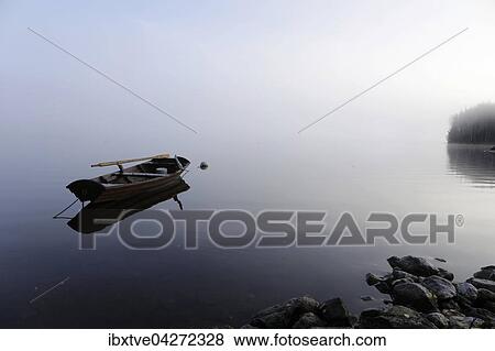 Ruderboot liegt im See bei Nebel, Varmeln, Varmland, Schweden, Europa View Large Photo Image Stock Photo - Ruderboot liegt im See bei Nebel, Varmeln, Varmland, Schweden, Europa. Fotosearch