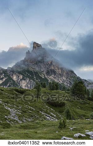 Stock Image - Sass de Stria, Hexenstein oder Hexenfels in den Wolken bei Sonnenaufgang, Falzarego-Pass, Dolomiten, Venetien, Italien, Europa. Fotosearch