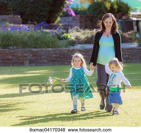 Schwangere Frau lauft mit ihren Tochtern uber eine Wiese im Park, Tintenpalast, Windhoek, Namibia, Afrika View Large Photo Image Stock Photo - Schwangere Frau lauft mit ihren Tochtern uber eine Wiese im Park, Tintenpalast, Windhoek, Namibia, Afrika. Fotosearch