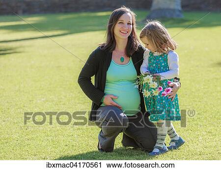Schwangere Frau mit Tochter auf einer Wiese im Park, Tintenpalast, Windhoek, Namibia, Afrika View Large Photo Image Stock Image - Schwangere Frau mit Tochter auf einer Wiese im Park, Tintenpalast, Windhoek, Namibia, Afrika. Fotosearch