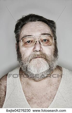 Stock Image - Senior mit Vollbart und Brille im Unterhemd, Portrait, Deutschland, Europa. Fotosearch