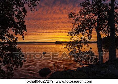Stock Photo - Sonnenuntergang, Abendstimmung, Wolkenformation, See Rusken, Smaland, Schweden, Europa. Fotosearch
