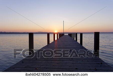 Sonnenuntergang am Steg bei St. Heinrich am Starnberger See, Funfseenland, Oberbayern, Bayern, Deutschland, Europa View Large Photo Image Stock Photography - Sonnenuntergang am Steg bei St. Heinrich am Starnberger See, Funfseenland, Oberbayern, Bayern, Deutschland, Europa. Fotosearch