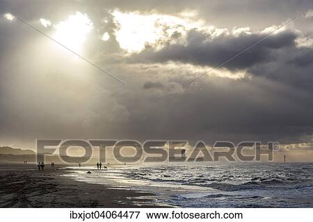 Stock Photo - Spazierganger, Nordseestrand, aufgewuhlte See, Wolkenberge, bei einem Herbststurm, De Haan, Flandern, Belgien, Europa. Fotosearch