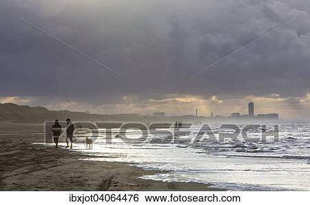 Spazierganger, Nordseestrand, aufgewuhlte See, Wolkenberge, bei einem Herbststurm, De Haan, Flandern, Belgien, Europa View Large Photo Image Stock Photograph - Spazierganger, Nordseestrand, aufgewuhlte See, Wolkenberge, bei einem Herbststurm, De Haan, Flandern, Belgien, Europa. Fotosearch