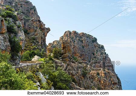 Stock Image - Strasse durch bizarre Felsformationen, Calanche, Les Calanches de Piana, Golf von Porto, Corse-du-Sud, Korsika, Frankreich, Europa. Fotosearch