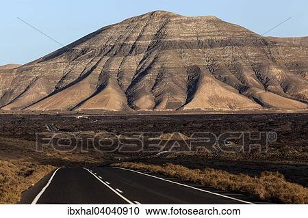 Strasse durch ein Lavafeld, bei Yaiza, hinten Atalaya de Femes, Abendlicht, Lanzarote, Kanarische Inseln, Spanien, Europa View Large Photo Image Stock Image - Strasse durch ein Lavafeld, bei Yaiza, hinten Atalaya de Femes, Abendlicht, Lanzarote, Kanarische Inseln, Spanien, Europa. Fotosearch