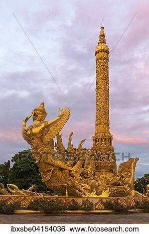 Thung Si Muang Park, Mueang, Garuda-Figur vor der Goldenen Riesen-Kerze, Kerzen-Monument, Ubon Ratchathani, Isan, Isaan, Thailand, Asien View Large Photo Image Stock Photograph - Thung Si Muang Park, Mueang, Garuda-Figur vor der Goldenen Riesen-Kerze, Kerzen-Monument, Ubon Ratchathani, Isan, Isaan, Thailand, Asien. Fotosearch