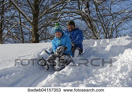 Stock Image - Vater und Sohn fahren Zipfelbob, Bad Heilbrunn, Oberbayern, Bayern, Deutschland, Europa. Fotosearch