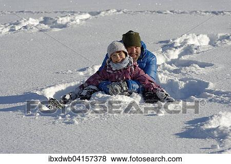 Vater und Tochter sitzen im tiefen Schnee, Bad Heilbrunn, Oberbayern, Bayern, Deutschland, Europa View Large Photo Image Stock Photo - Vater und Tochter sitzen im tiefen Schnee, Bad Heilbrunn, Oberbayern, Bayern, Deutschland, Europa. Fotosearch