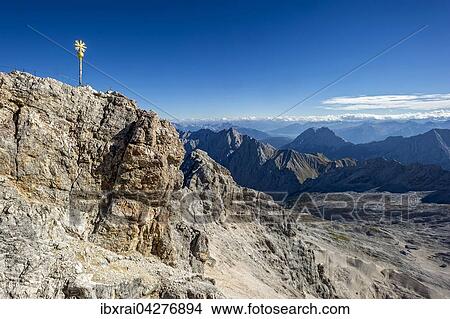 Vergoldetes Gipfelkreuz am Gipfel der Zugspitze, hinten Mieminger Gebirge in Tirol, Garmisch-Partenkirchen, Wettersteingebirge, Werdenfelser Land, Ostalpen, Oberbayern, Bayern, Deutschland, Europa View Large Photo Image Picture - Vergoldetes Gipfelkreuz am Gipfel der Zugspitze, hinten Mieminger Gebirge in Tirol, Garmisch-Partenkirchen, Wettersteingebirge, Werdenfelser Land, Ostalpen, Oberbayern, Bayern, Deutschland, Europa. Fotosearch