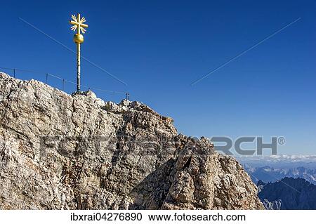 Vergoldetes Gipfelkreuz am Gipfel der Zugspitze, hinten Ausblick nach Tirol, Garmisch-Partenkirchen, Wettersteingebirge, Ostalpen, Oberbayern, Bayern, Deutschland, Europa View Large Photo Image Stock Image - Vergoldetes Gipfelkreuz am Gipfel der Zugspitze, hinten Ausblick nach Tirol, Garmisch-Partenkirchen, Wettersteingebirge, Ostalpen, Oberbayern, Bayern, Deutschland, Europa. Fotosearch