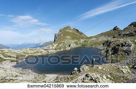 Stock Photo - Wanderer an einem Bergsee, Rauhenbergsee im Klafferkessel, Seenplatte, Rohrmoos-Untertal, Schladminger Tauern, Steiermark, Osterreich, Europa. Fotosearch