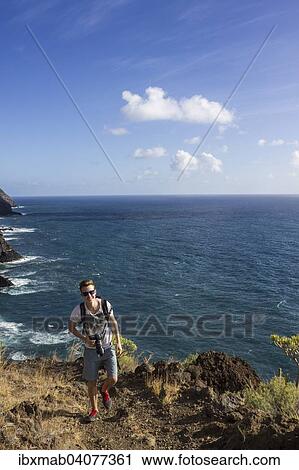 Stock Image - Wanderer auf Wanderweg uber dem Meer, Steilkuste, La Palma, Kanarische Inseln, Spanien, Europa. Fotosearch