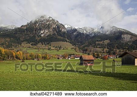Stock Photo - Wiese mit kleinen Hutten, Ostrachtal bei Bad Oberdorf, hinten die Allgauer Berge, Herbststimmung, Allgau, Bayern, Deutschland, Europa. Fotosearch