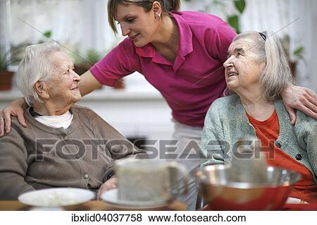 Zwei altere Frauen, 78 Jahre und 88 Jahre, und Pflegeschwester, 31 Jahre, Freizeitbeschaftigung im Altersheim View Large Photo Image Stock Photo - Zwei altere Frauen, 78 Jahre und 88 Jahre, und Pflegeschwester, 31 Jahre, Freizeitbeschaftigung im Altersheim. Fotosearch