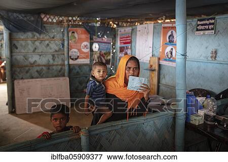 Stock Photo - A mother with her children in a medical station in the camp for Rohingya refugees from Myanmar, Kutupalong, Cox Bazar, Bangladesh, Asia. Fotosearch