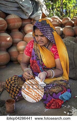 A woman painting pots and water jugs at a pottery stall in Jaipur, Rajasthan, India, Asia View Large Photo Image Stock Image - A woman painting pots and water jugs at a pottery stall in Jaipur, Rajasthan, India, Asia. Fotosearch