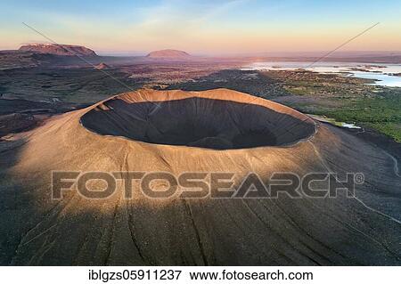 Stock Photo - Aerial view of the tuffring crater Hverfjall in the evening light in the Krafla volcano system in the Mývatn region rising out of a green plain, in the background the lake Mývatn, Skútustaðir, Norðurland eystra, Iceland, Europe. Fotosearch