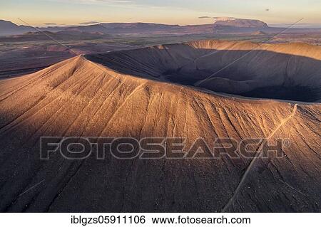 Stock Photograph - Aerial view of the tuffring crater Hverfjall in the evening light in the Krafla volcano system in the Mývatn region rising from the green plain, Skútustaðir, Norðurland eystra, Iceland, Europe. Fotosearch