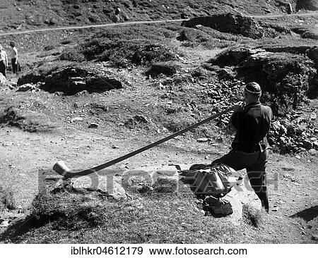 Alphorn player ca. 1950, Switzerland, Europe View Large Photo Image Stock Photo - Alphorn player ca. 1950, Switzerland, Europe. Fotosearch