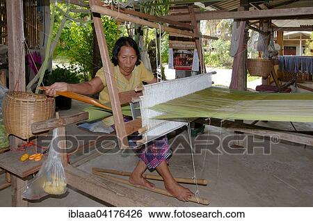 An elderly Tai Dam woman working on an old wooden loom, Loei province, Thailand, Asia View Large Photo Image Stock Photograph - An elderly Tai Dam woman working on an old wooden loom, Loei province, Thailand, Asia. Fotosearch