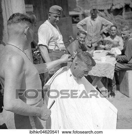 Stock Image - Approx. 1939, 1941, training Wehrmacht, soldiers during haircutting, Ulm, Germany, Europe. Fotosearch