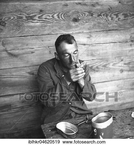 Stock Photo - Approx. 1939, 1941, training Wehrmacht, man uses Wehrmacht badge as a mirror, Ulm, Germany, Europe. Fotosearch