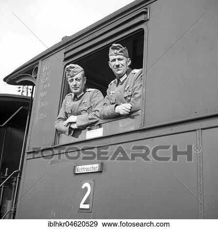 Stock Photo - Approx. 1939, 1941, training Wehrmacht, two Wehrmacht soldiers look out of a train window, Ulm, Germany, Europe. Fotosearch