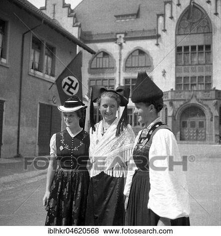 Approx. 1939, 1941, women in traditional costumes posing, in the background a swastika flag, Freiburg, Germany, Europe View Large Photo Image Stock Photo - Approx. 1939, 1941, women in traditional costumes posing, in the background a swastika flag, Freiburg, Germany, Europe. Fotosearch