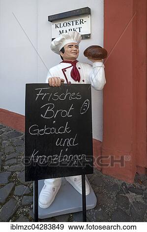 Baker figure with chalkboard in front of the monastery shop, Cistercian Abbey, Stift St. Marienthal on the Neisse, Oberlausitz, Saxony, Germany, Europe View Large Photo Image Stock Photo - Baker figure with chalkboard in front of the monastery shop, Cistercian Abbey, Stift St. Marienthal on the Neisse, Oberlausitz, Saxony, Germany, Europe. Fotosearch