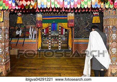 Bhutanese man at prayer at the holy shrine, Punakha Dzong monastery fortress, Punakha District, Bhutan, Asia View Large Photo Image Stock Image - Bhutanese man at prayer at the holy shrine, Punakha Dzong monastery fortress, Punakha District, Bhutan, Asia. Fotosearch