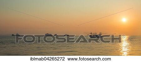 Boat in the sea at sunset in front of small islands, Koh Samui, Gulf of Thailand, Thailand, Asia View Large Photo Image Stock Image - Boat in the sea at sunset in front of small islands, Koh Samui, Gulf of Thailand, Thailand, Asia. Fotosearch